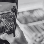 Person holding a phone, recording a reel of food.