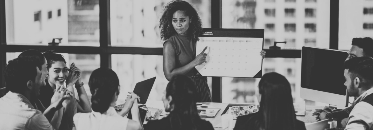 Woman holding calendar in front of meeting