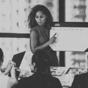 Woman holding calendar in front of meeting