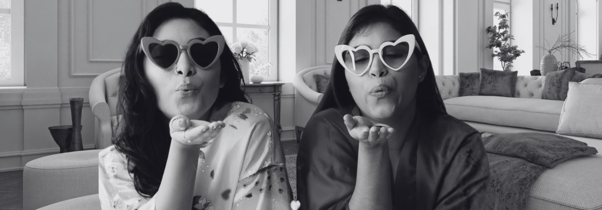 two girls with heart glasses on